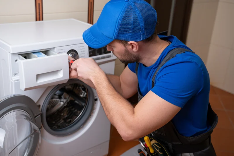 Expert technician repairing control panel on a washer machine.